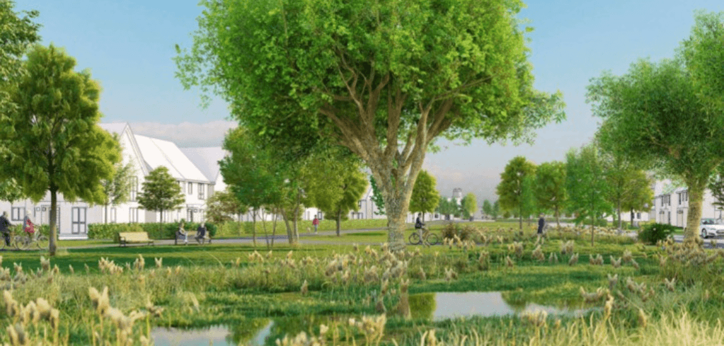 A lush green park with tall trees, a pond, cyclists, and white residential buildings in the background under a clear sky.