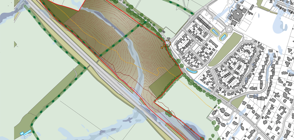 Urban planning map showing a red-outlined development zone near a road, adjacent to a residential area with buildings and green spaces.
