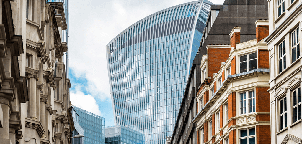 London cityscape with curved glass skyscraper (Walkie-Talkie building) rising between historic brick buildings