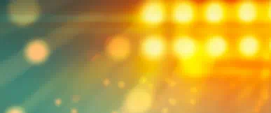 A warm, abstract background featuring soft golden and amber light flares with a gentle blur effect. The glowing tones create a modern, uplifting feel, suggesting energy, opportunity, and forward momentum.