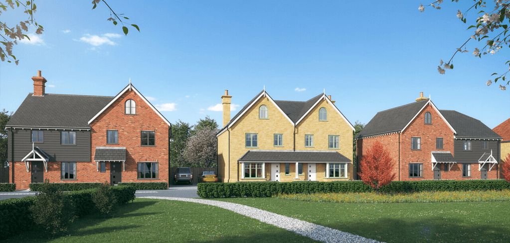 Row of modern brick homes with pitched roofs in red and yellow, fronted by manicured lawns and hedges under blue sky.