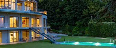 An exceptional super-prime residence set within expansive, private grounds, combining striking contemporary architecture with refined detailing. Floor-to-ceiling glazing fills the interiors with natural light, while the landscaped gardens and illuminated outdoor pool create an atmosphere of privacy, luxury and exclusivity. Designed for those seeking the highest standards of modern living.