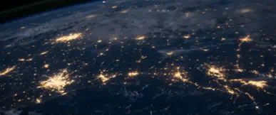 A striking view of the Earth illuminated at night, symbolising global reach, connectivity and international opportunity. The image reflects a worldwide perspective, supporting seamless property services and expert guidance for clients operating across borders and time zones.
