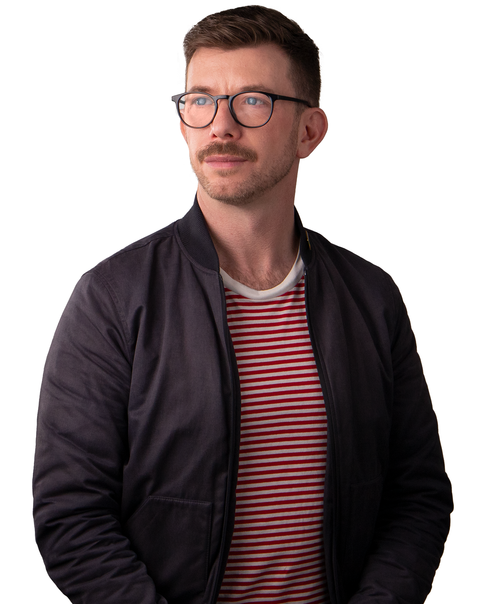 Man with blue eyes, glasses and a moustache. Wearing a black jacket and Red and white striped t- shirt.