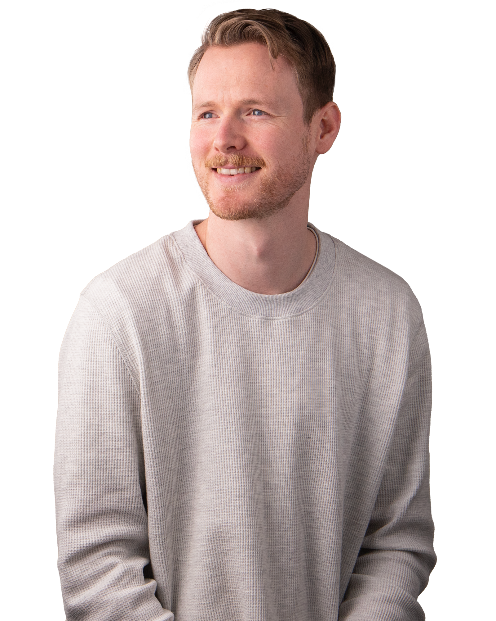 Man with off white coloured, long sleeved shirt, smiling.