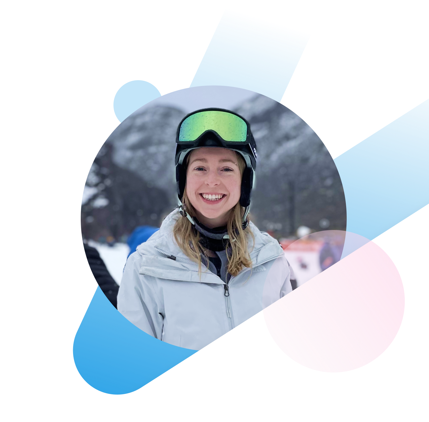 A woman smiling while wearing ski googles and a warm jacket. 