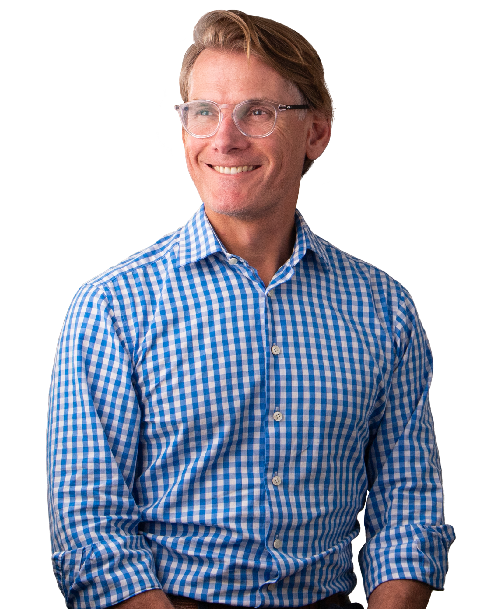 A man wearing clear glasses and a business shirt is smiling. 