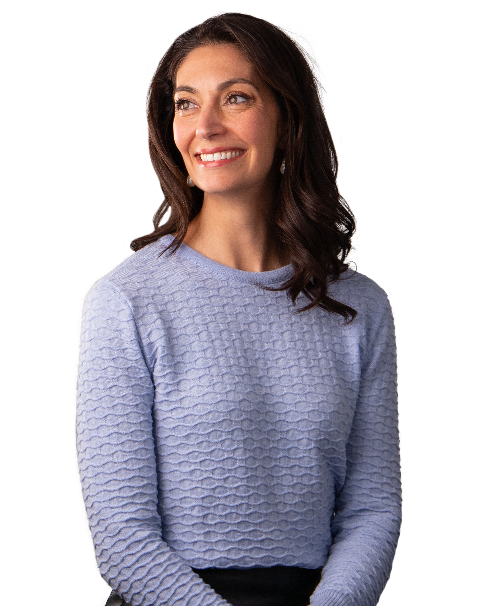 Woman with dark hair, wearing a blue top, smiling.