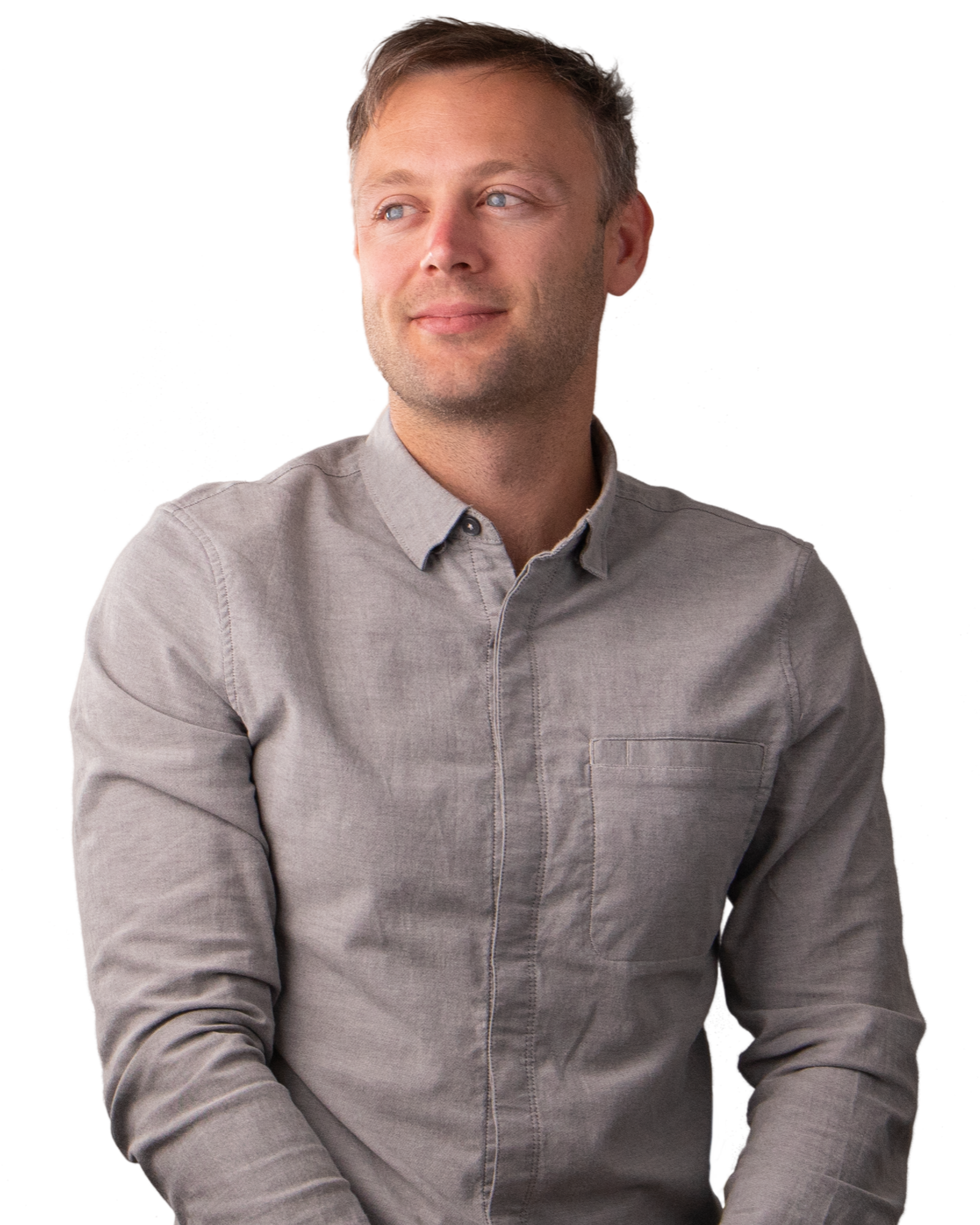 A man wearing a grey shirt smiling