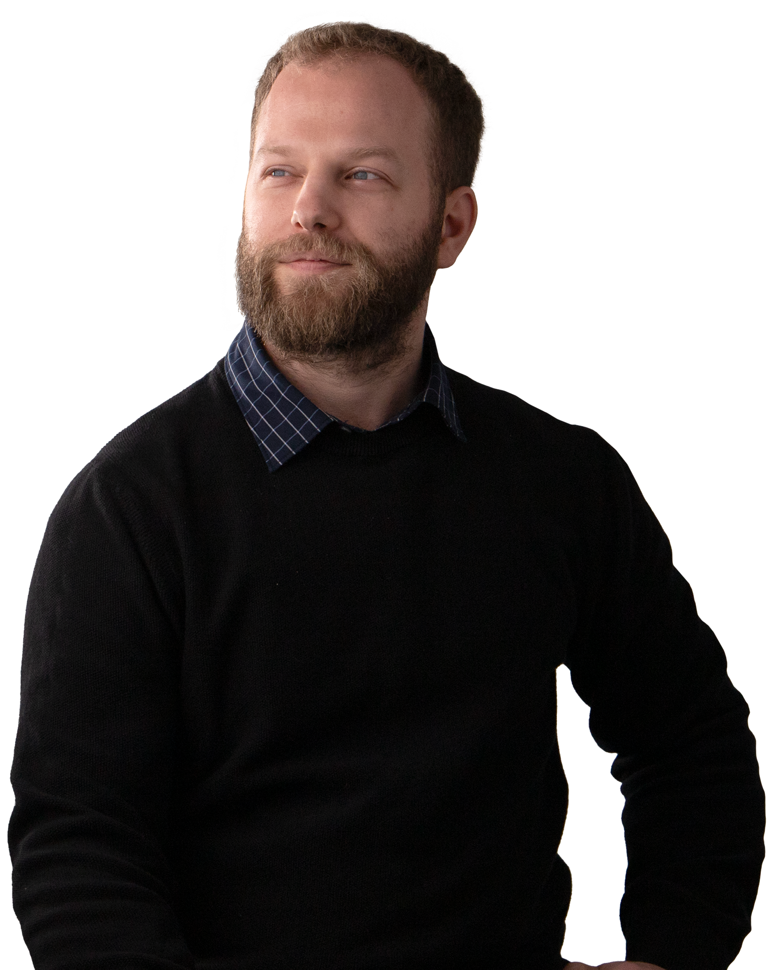 Man with a beard wearing a black sweatshirt. Smiling.