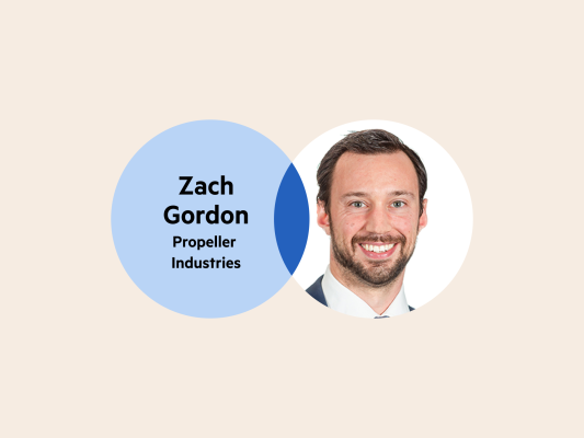 A Venn diagram: the left circle is pale blue with the words 'Zach Gordon, Propeller Industries' and the right circle is Zach's headshot. The circle overlap is a dark blue.
