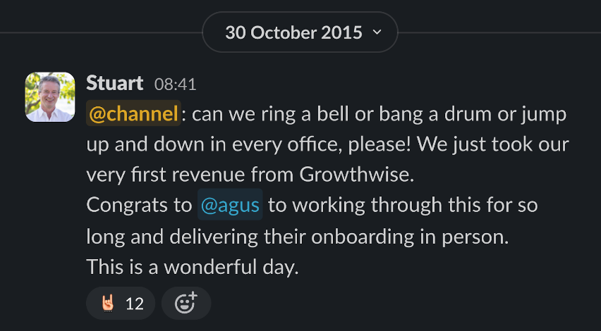 A screenshot of a Slack message from Karbon co-founder and then-CEO on 30 October 2015. The message informs the Karbon team of their very first paying customer, Growthwise.