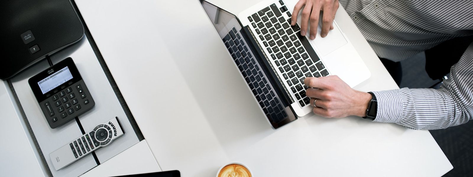 An accounting professional setting showing a payroll checklist template on a laptop with additional payroll processing tools like a calculator and tablet on the desk, exemplifying streamlined payroll best practices.