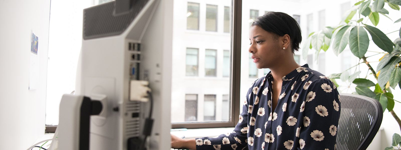 An accountant working on individual tax return forms 1040/1041 using a tax form template, in a well-lit office space.