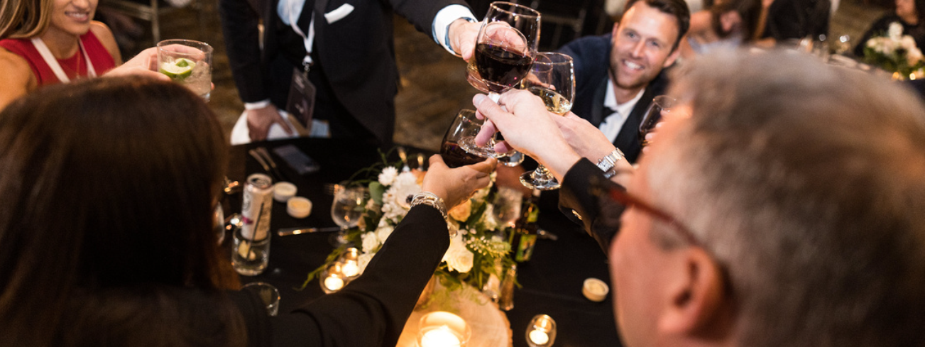 Karbon excellence awards photo. A group of Karbon X attendees toast their drinks to celebrate awards.