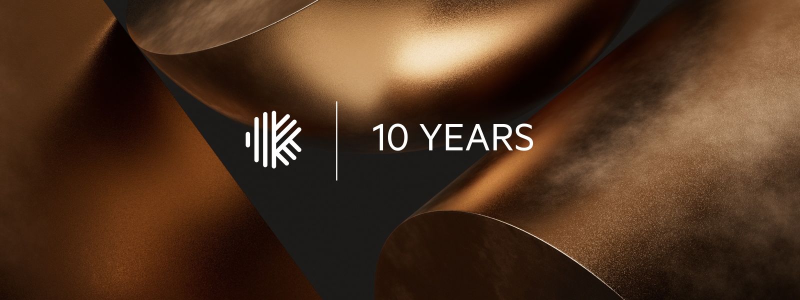 Karbon's 10th anniversary celebration graphic with metallic gold shapes and the company logo.