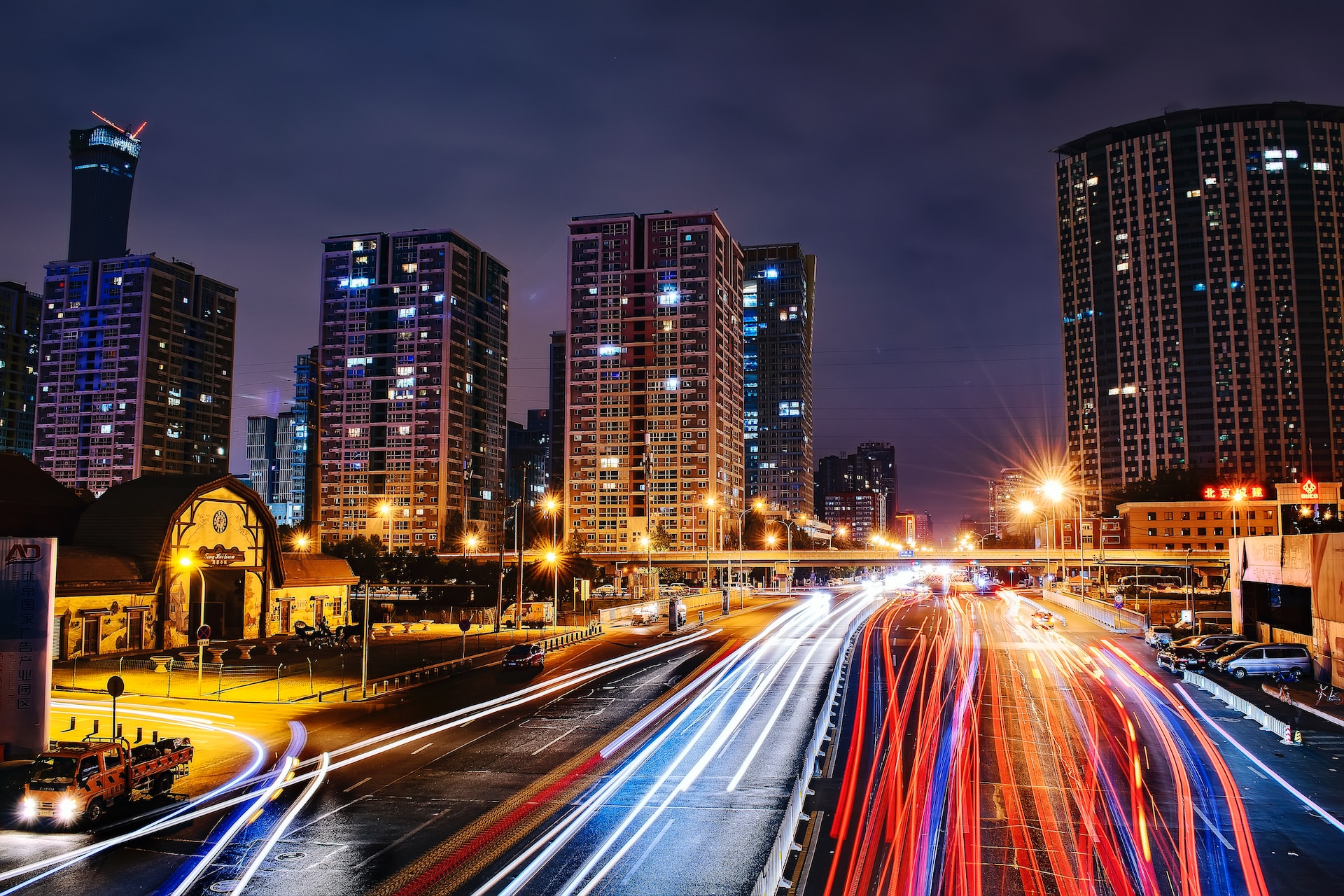 A long exposure image of a busy street at dust — the car headlights are blurred lines.