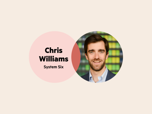 A Venn diagram. The left circle has the words 'Chris Williams System Six' and the right circle is Chris' headshot. He has short brown hair, a short beard and is wearing a light blue collared shirt and a dark blue blazer.