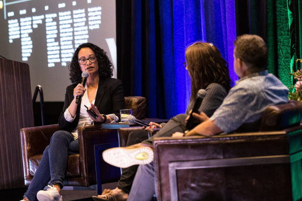 Karbon's SVP of Customer, Andi Ancheta, on stage at Karbon X 22 with Jessica and Greg Daley during their 'Journey to Practice Excellence' session.