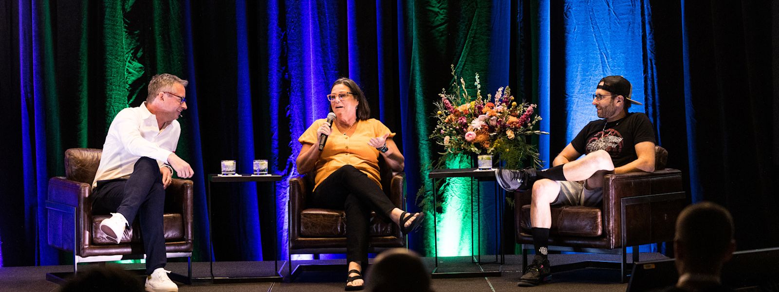Stuart McLeod on stage at Karbon X 2022, hosting a live episode of the Accounting Leaders Podcast, with guests Rebecca Berneck and Scott Scarano.