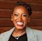 Keila Hill-Trawick, MBA, CPA smiles brightly in her work clothes.