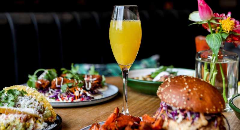 Close up of mimosa and bottomless brunch dishes at House of Lulu White in Melbourne