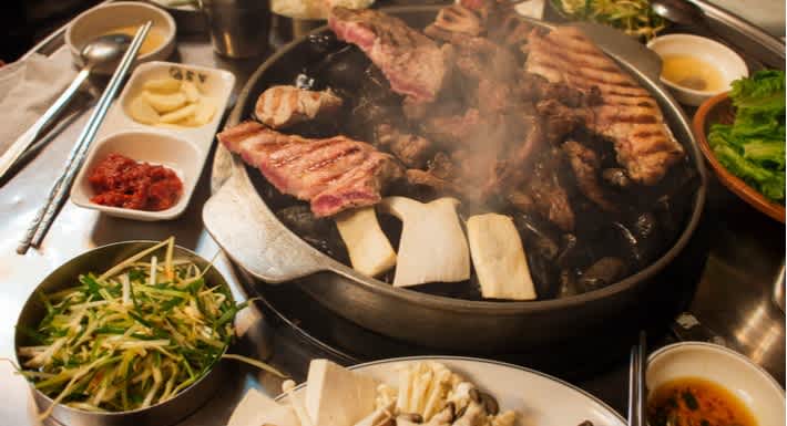 Succulent meats cooking on the grill & a range of banchan. Delicious. Source: Shutterstock \[…\]