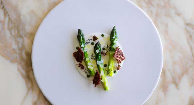 An entrée from Ormeggio featuring green asparagus and buttermilk. Source: Quandoo