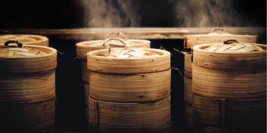 Bamboo steamers with delicious dumplings inside 