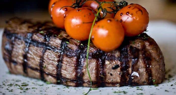 Beautifully cooked Steak from Comedor Grill & Bar with cherry tomatoes on top 