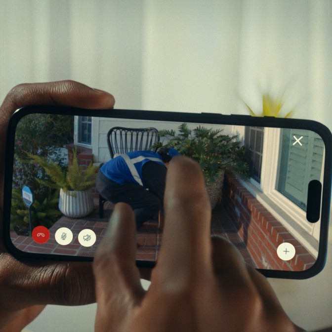 Delivery driver dropping a package at the front door of a house