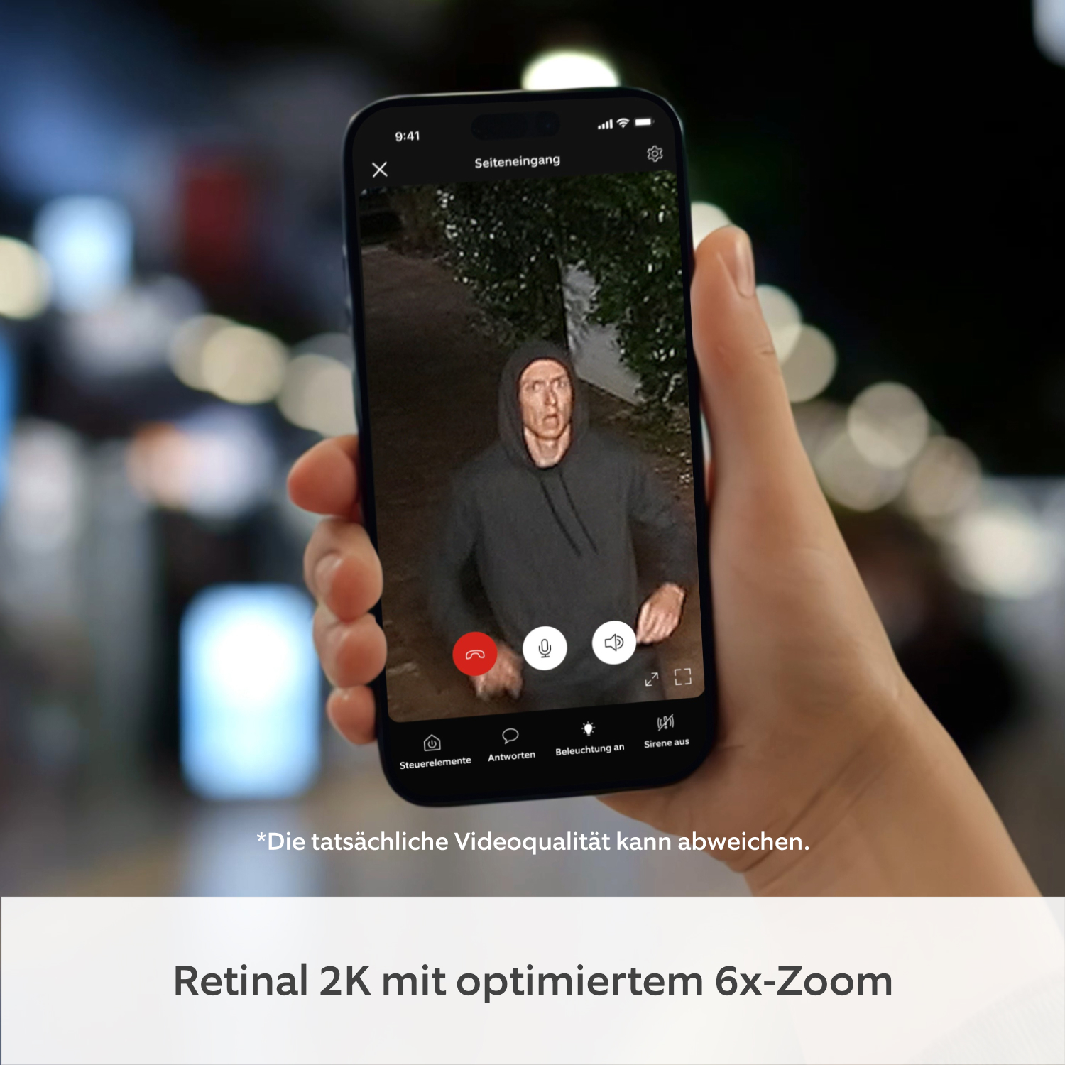 Spotlight Kamera Netzstecker (neueste Generation) (for Spotlight Cam) - Hand hält Smartphone mit Ring App, Live-Video von Spotlight Cam (2nd Gen) zeigt Person in Kapuzenpullover.