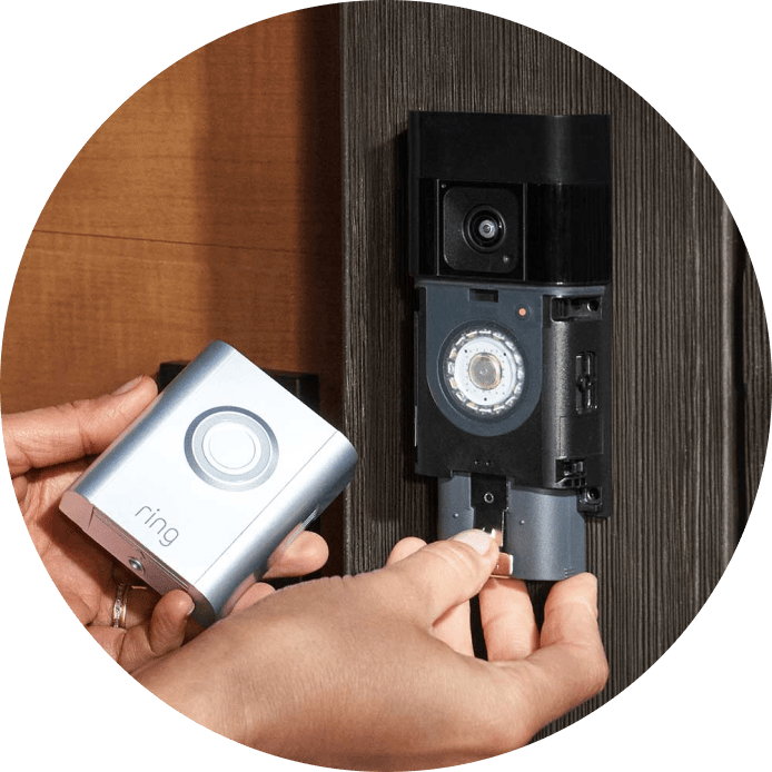 Hands inserting Quick Release Battery Pack into the Ring Battery Video Doorbell Pro during setup.