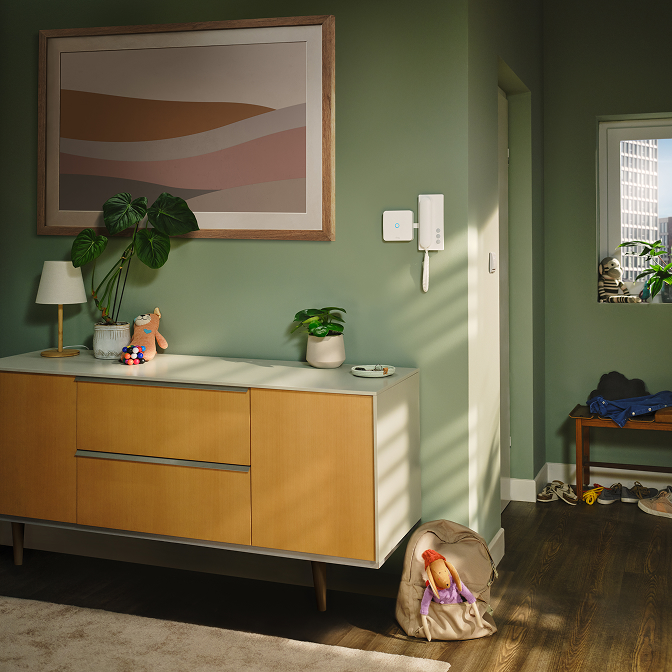 A family entering in the room with a wall where Ring Intercom Audio is placed.