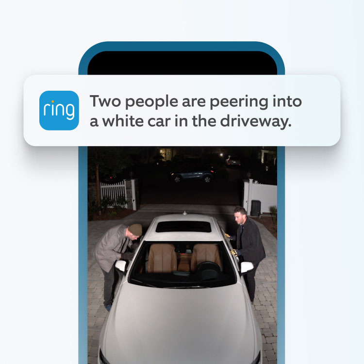 A Ring app screenshot showing two men trying to enter a car. The notification 