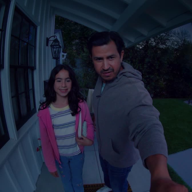 Video of father and daughter outside the house at night, showing scene change from dark, to well-lit with clear visibility