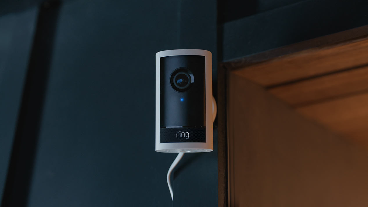 Outdoor Camera Pro, mounted on the corner of a white house.