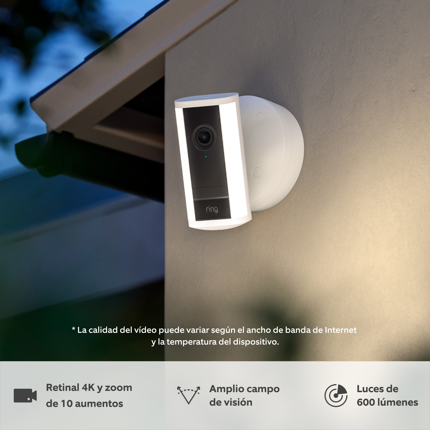 Cámara Pro con luces cableada (última generación) (for Spotlight Cam Pro Wired (2nd Gen)) - Se muestra una cámara Pro con luces Ring (última generación) blanca instalada en la pared al atardecer bajo la lluvia, con las luces LED integradas encendidas.