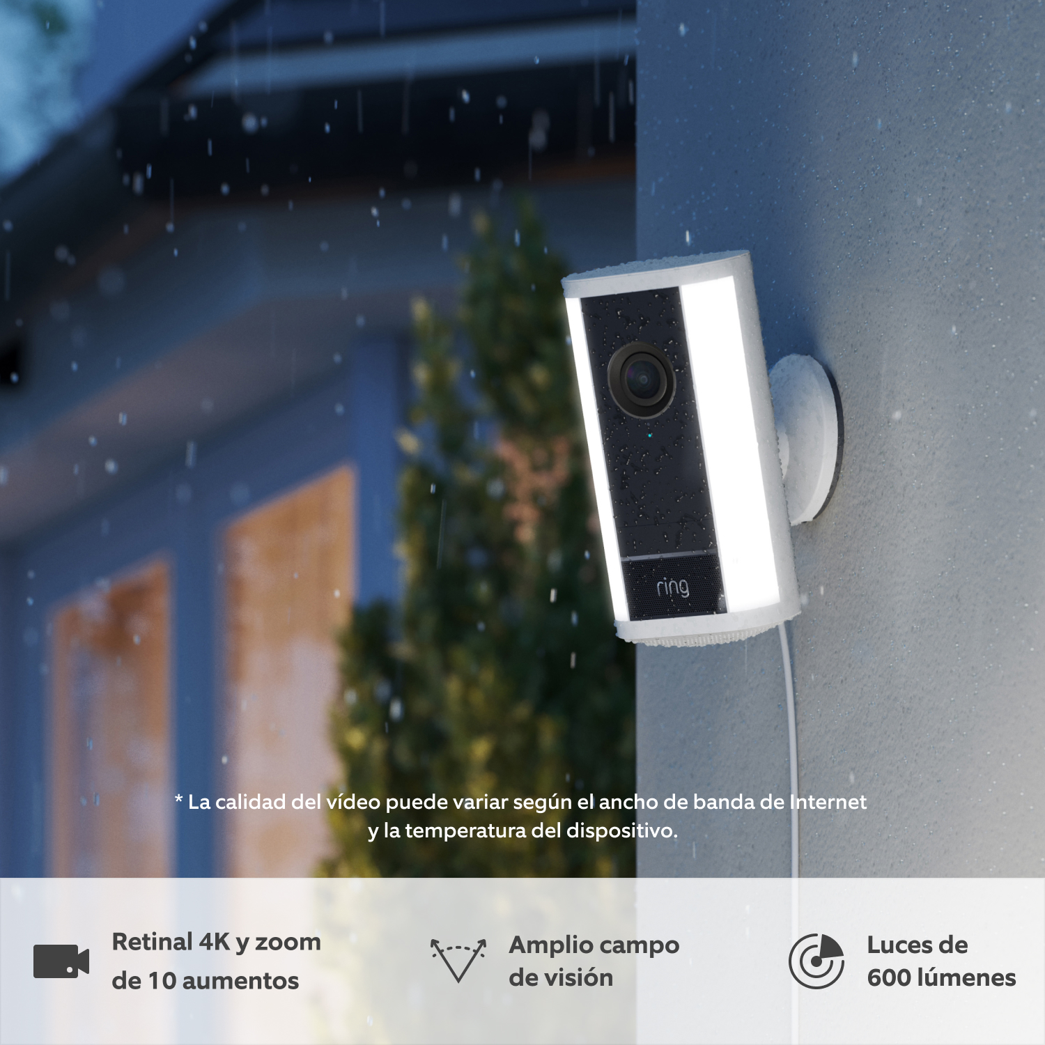 Pack de 2 Cámara Pro con luces (última generación) con adaptador de enchufe (for Spotlight Cam Pro Plug-In (2nd Gen)) - Se muestra una cámara Pro con luces Ring (última generación) blanca instalada en la pared al atardecer bajo la lluvia, con las luces LED integradas encendidas.