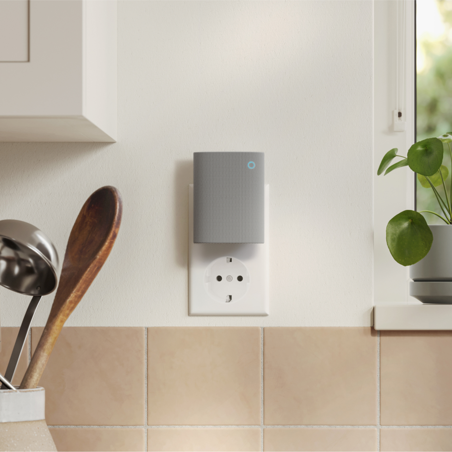 Chime (3rd Gen) - Chime (3rd Gen) plugged into wall socket in a kitchen. Below are terracotta tiles and utensil jar. Small plant nearby