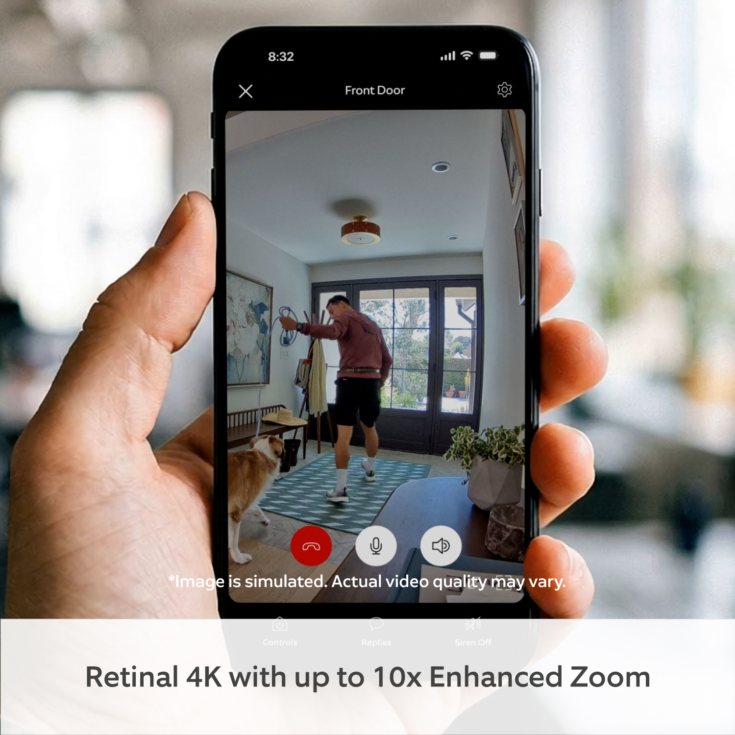 Indoor Camera 4K - Hand holding a phone showing an Indoor Camera 4K view of a person and dog in a home entryway.