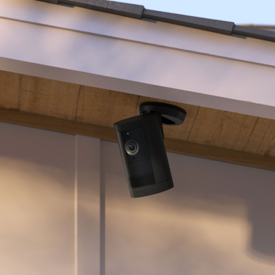 Black Ring Outdoor Camera Plus mounted upside down under eave outdoors, showing versatile installation options.