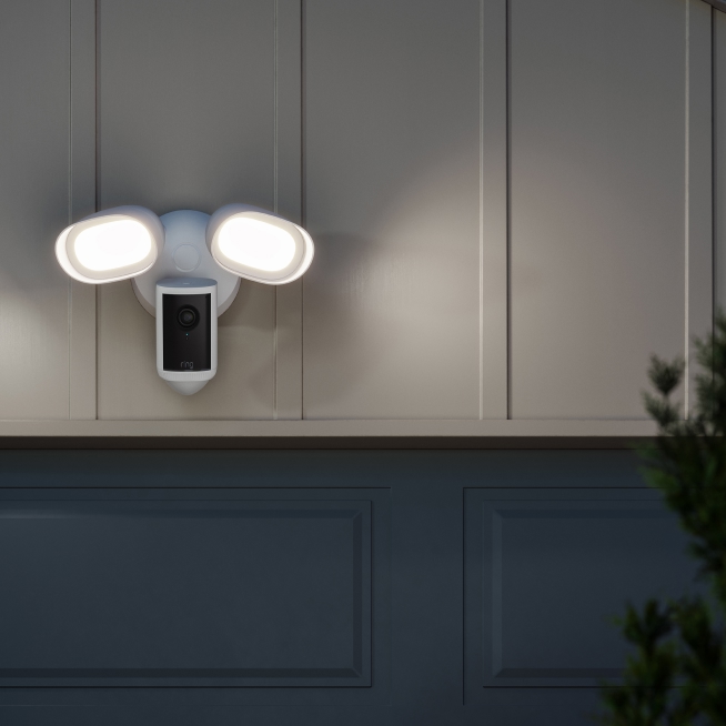 Floodlight Cam Pro (2nd Gen) mounted on garage wall, activates floodlight and sends alerts when movement is detected 