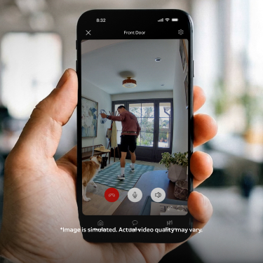 Smartphone displaying Ring Indoor Camera 4K live view of a modern kitchen through the Ring app, with control options on screen.