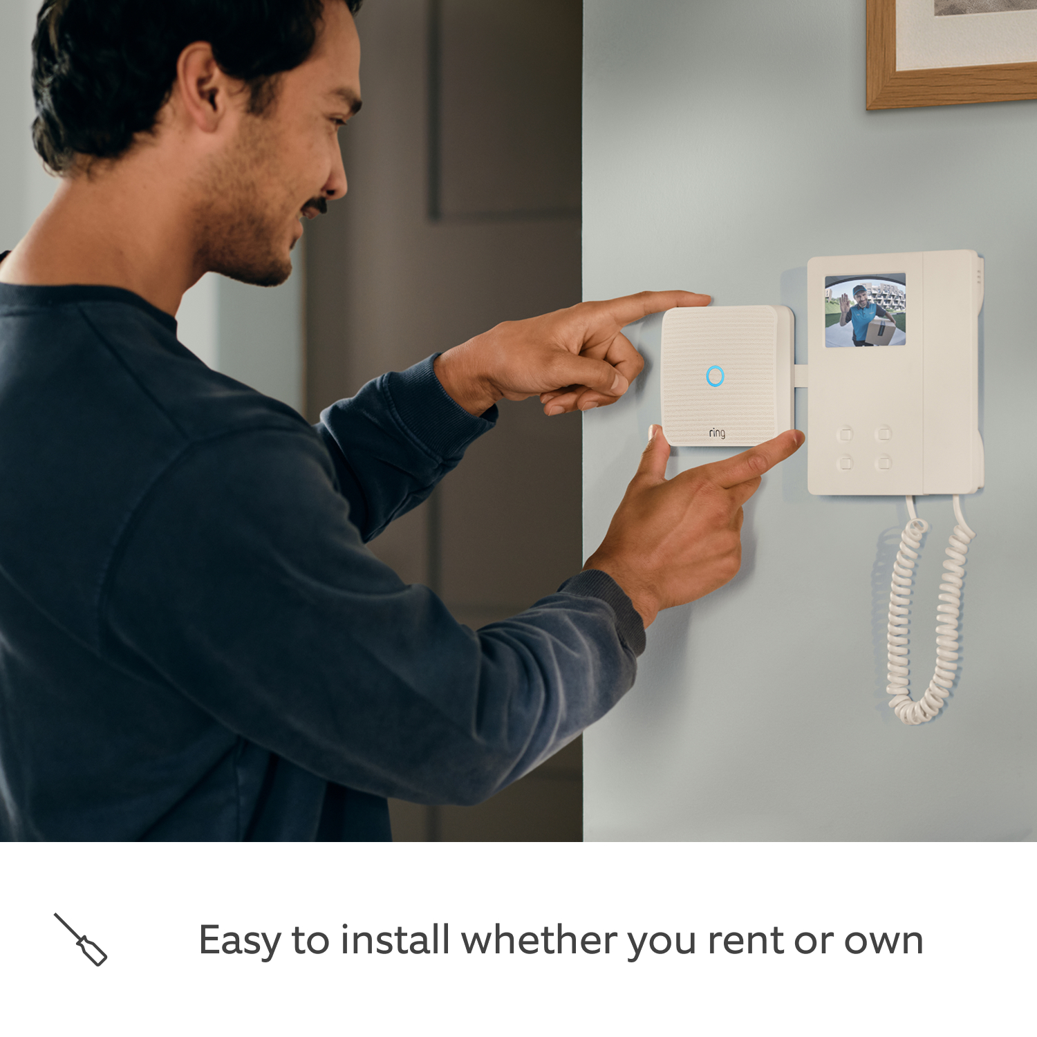 Ring Intercom Video + Indoor Camera 2nd Gen - A guy installing a Ring Intercom Video.