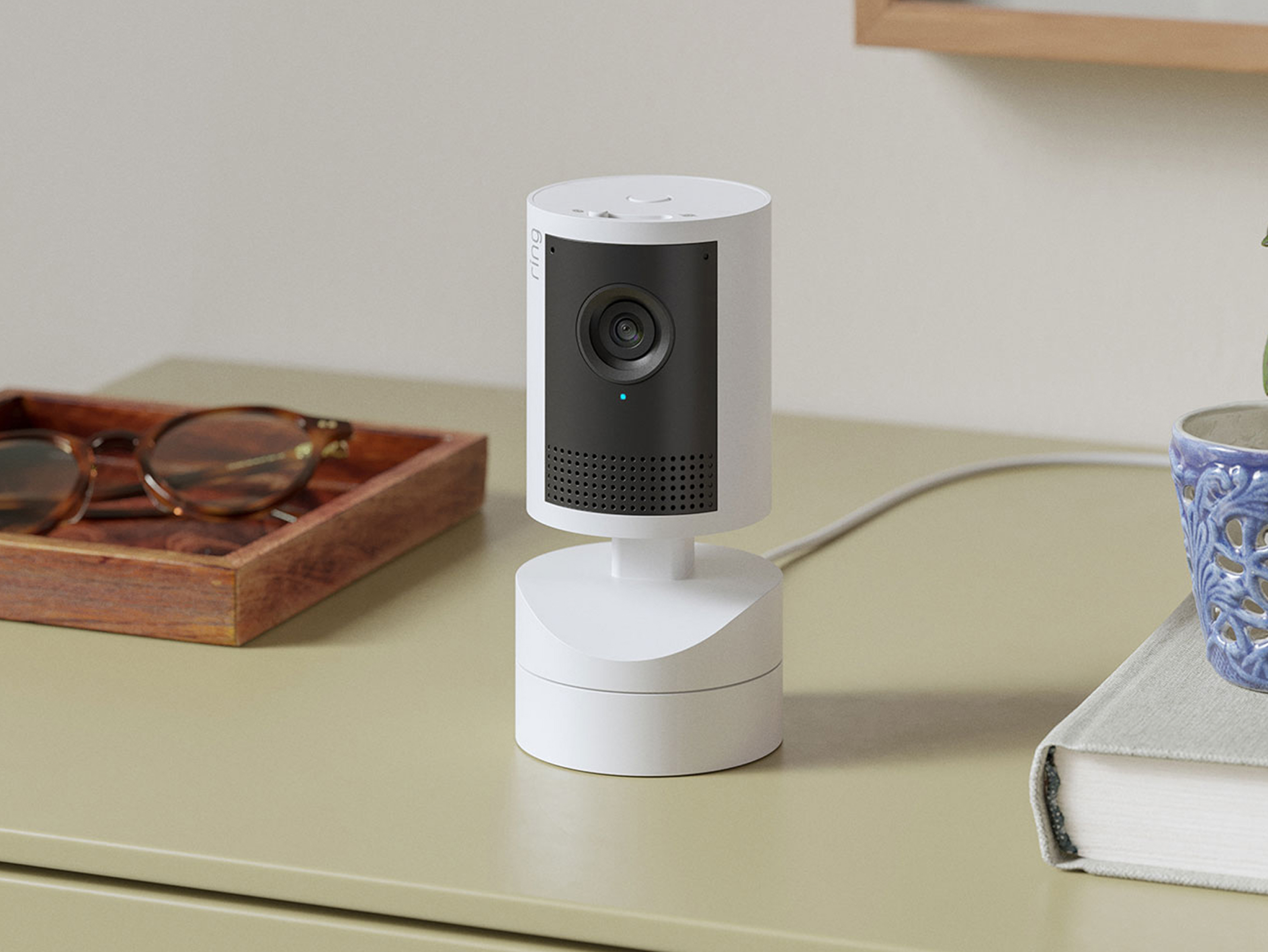 White Pan-tilt Indoor Camera 2K placed on a tabletop.
