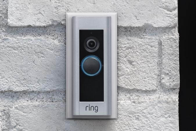 Ring Video Doorbell Pro mounted with Retro Fit Kit on a white painted brick wall, covering previous installation marks.