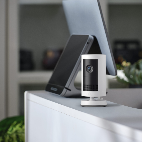 Ring Outdoor Camera Plus placed near POS terminal in store, showing flexible placement indoors or out.
