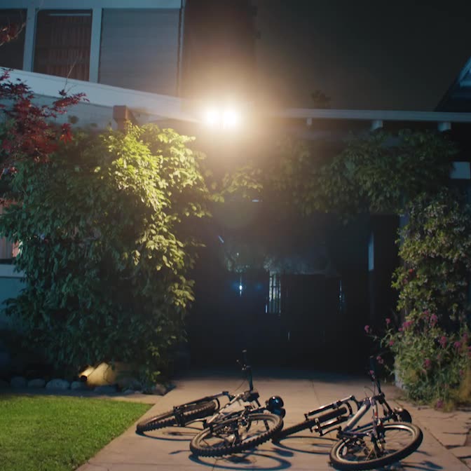 Floodlight Cam Pro (2nd Gen)'s powerful lights activate as two teens attempt bike theft in driveway, causing them to flee