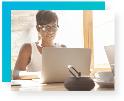 Selling Points - Woman sitting at computer in room backlit by large windows